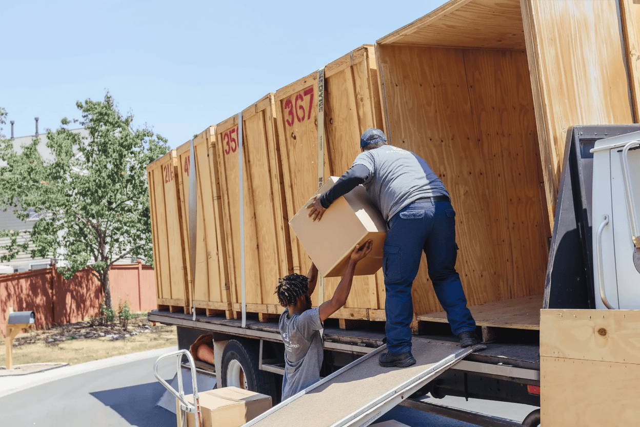 Movers moving boxes into moving truck