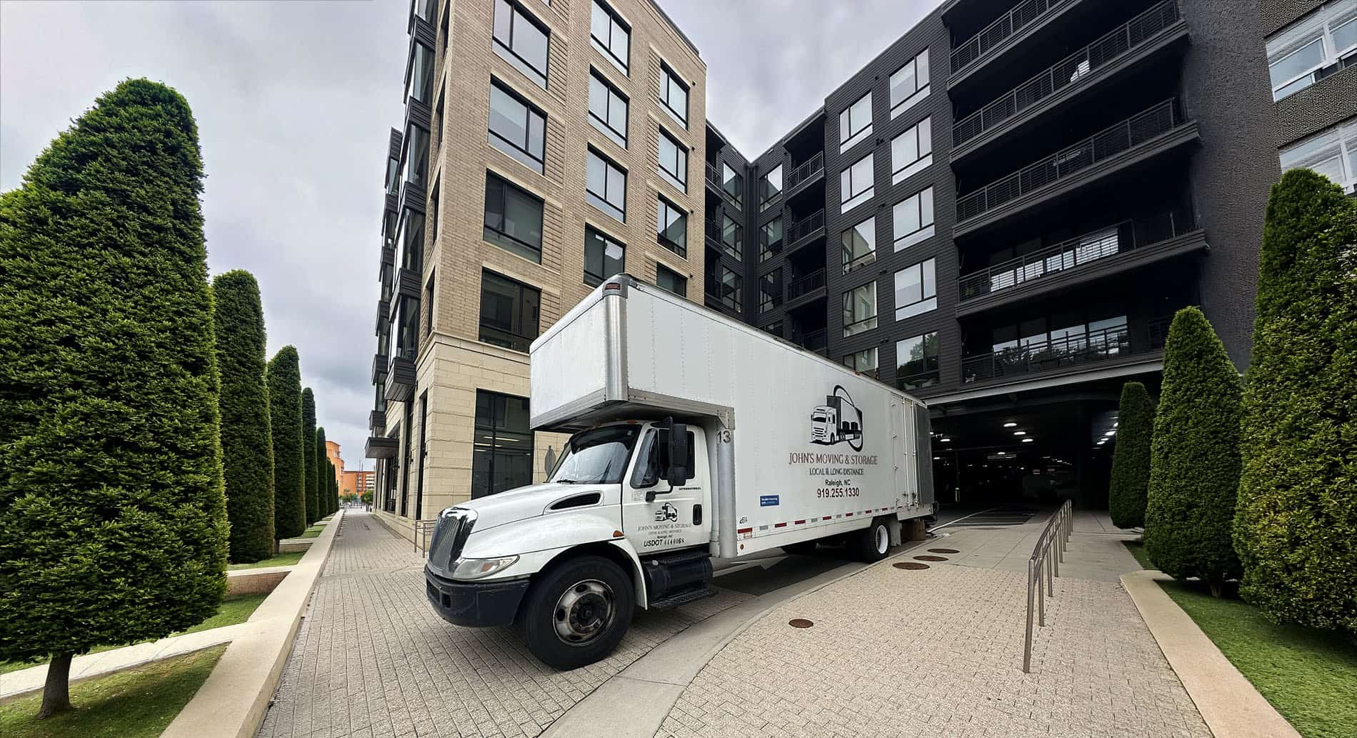 John's Moving and Storage crew and trucks representing a Raleigh apartment or condo move